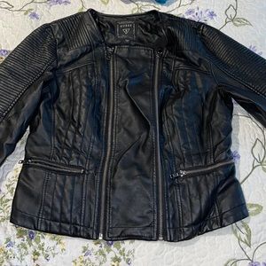 Black leather jacket can zip up from either side. Couple of scratches on jacket